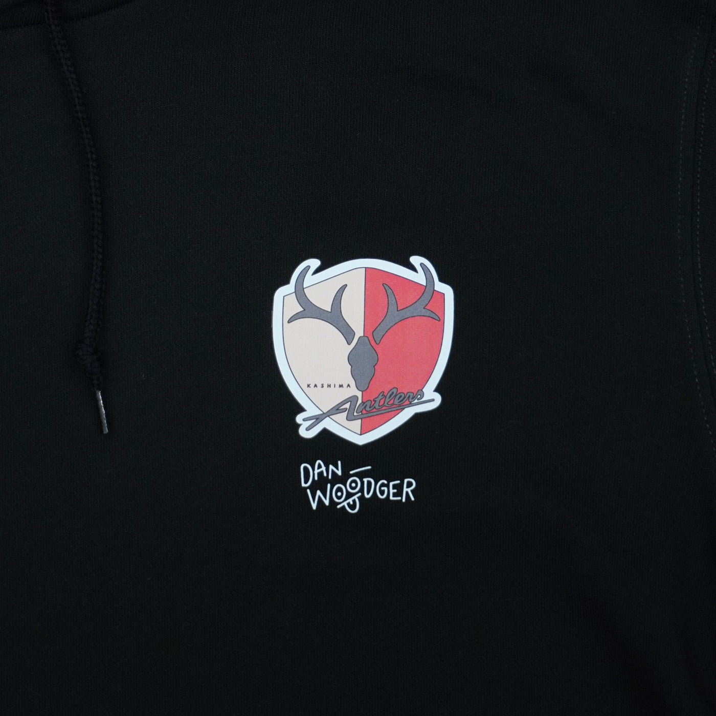 DAN-WOODGER × KASHIMA ANTLERS フーディ（ブラック）